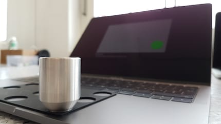 Calibrating the trackpad with weights.